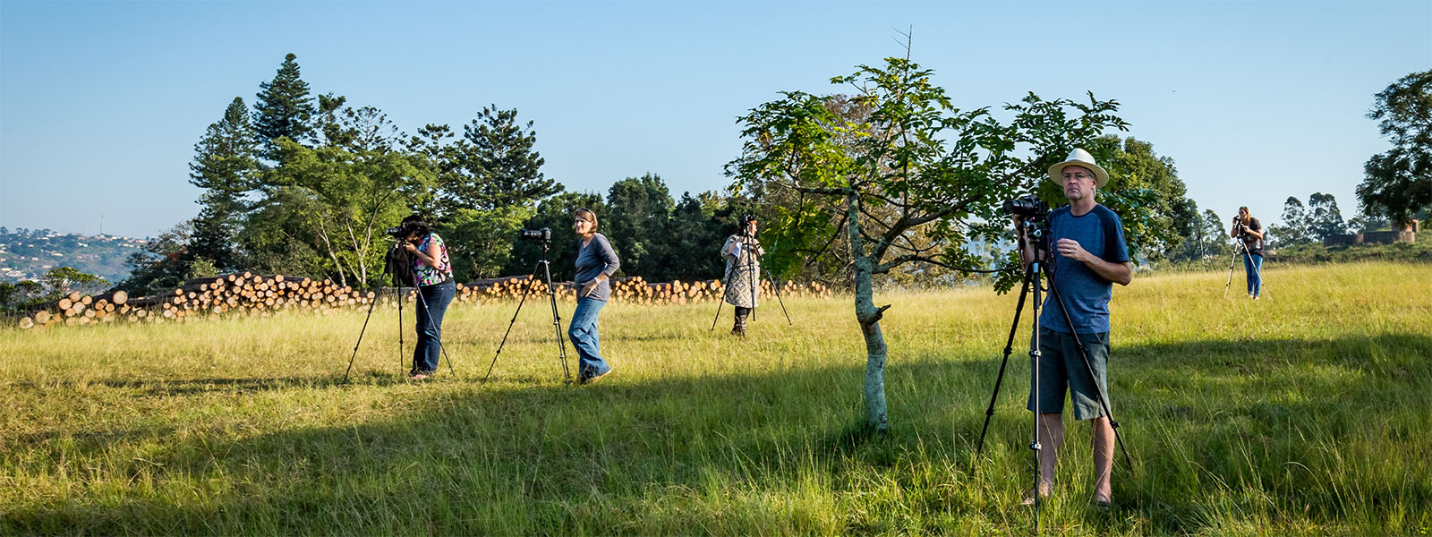Photography students practising camera settings during a guided outdoor session